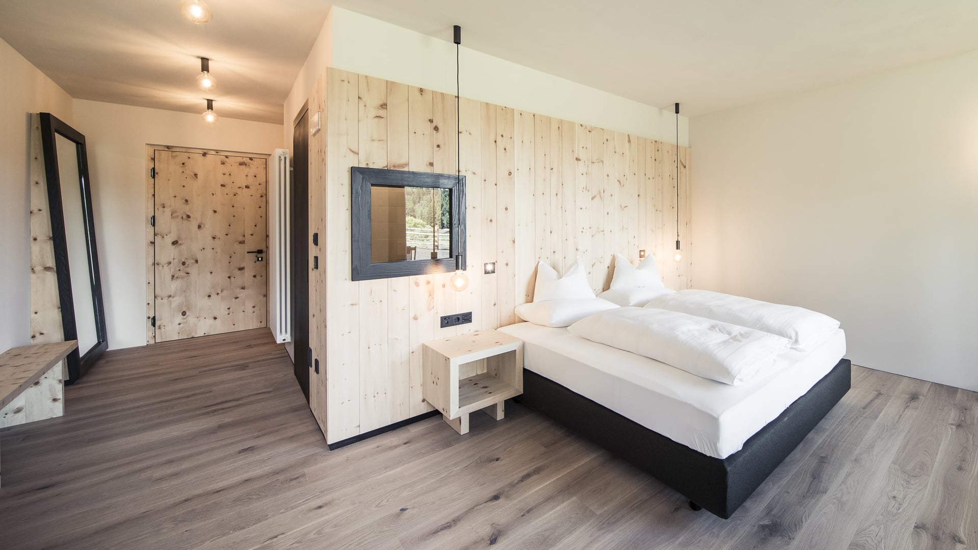 Designzimmer mit Naturholzmöbeln und Blick auf die Dolomiten